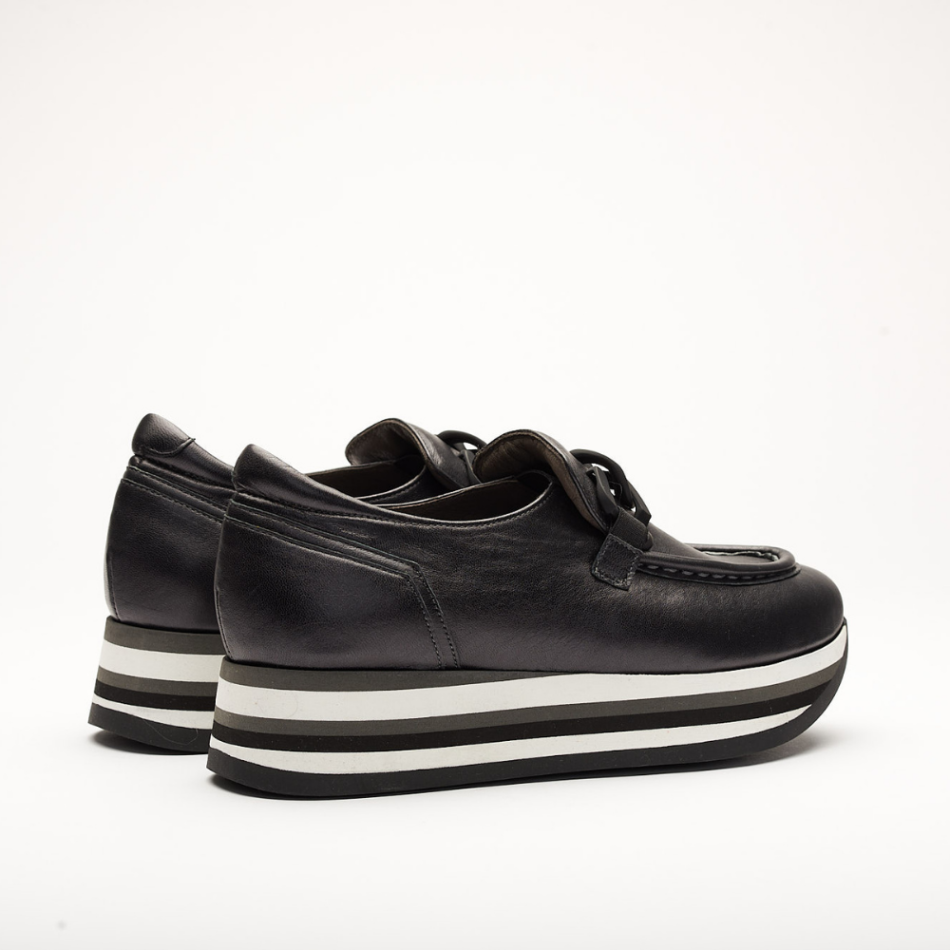4cm platform shoe with white, black and grey stripes made entirely of leather. It is made in Sena Black. It has a Black application on the front of the shoe and the back is padded.